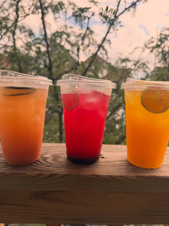 Three Coffee Baby refreshers on a porch rail